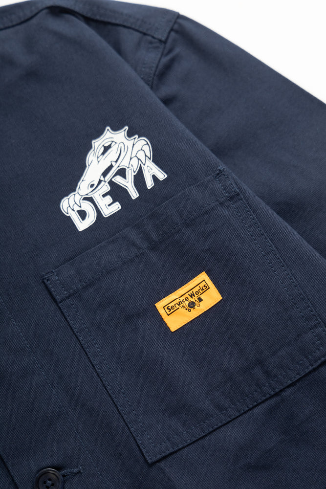 DEYA x Service Works Navy Blue BOH Coverall Jacket - close up DEYA Logo