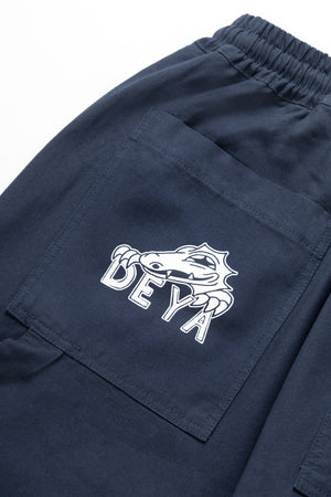 DEYA x Service Works Navy Blue BOH Pants - close up DEYA Logo