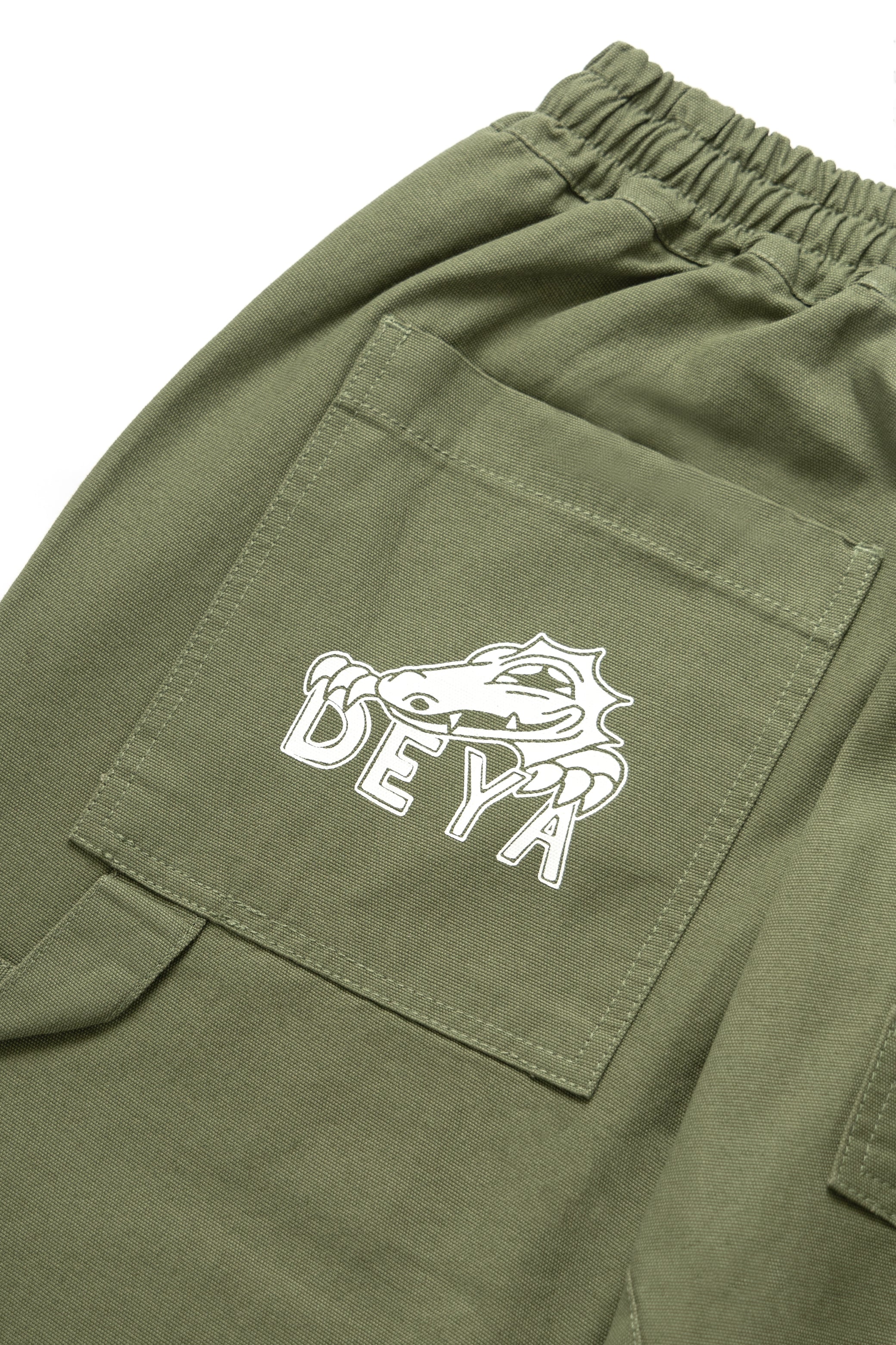 DEYA x Service Works Olive Green FOH Pants - DEYA logo close up