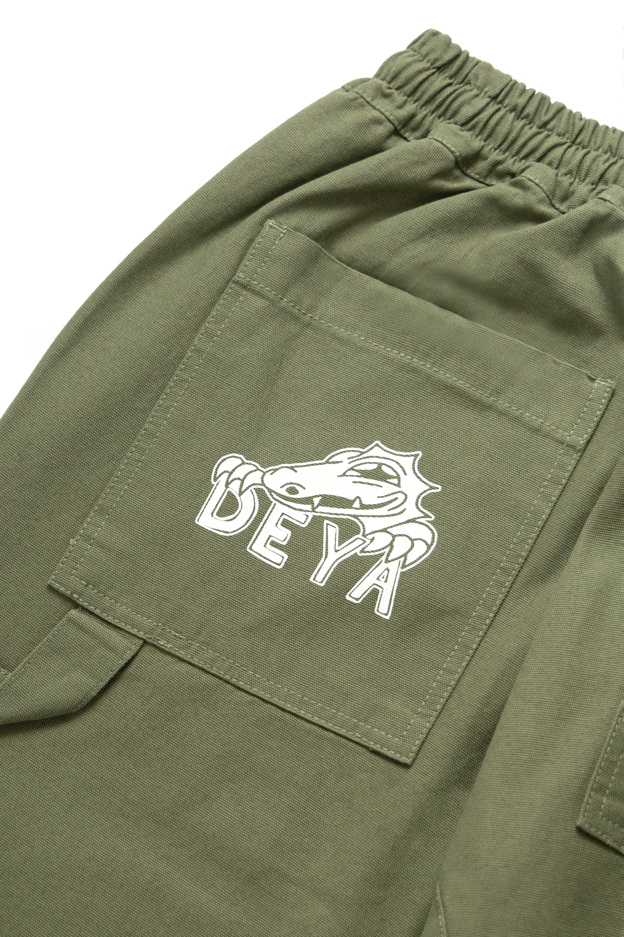 DEYA x Service Works Olive Green FOH Pants - DEYA logo close up